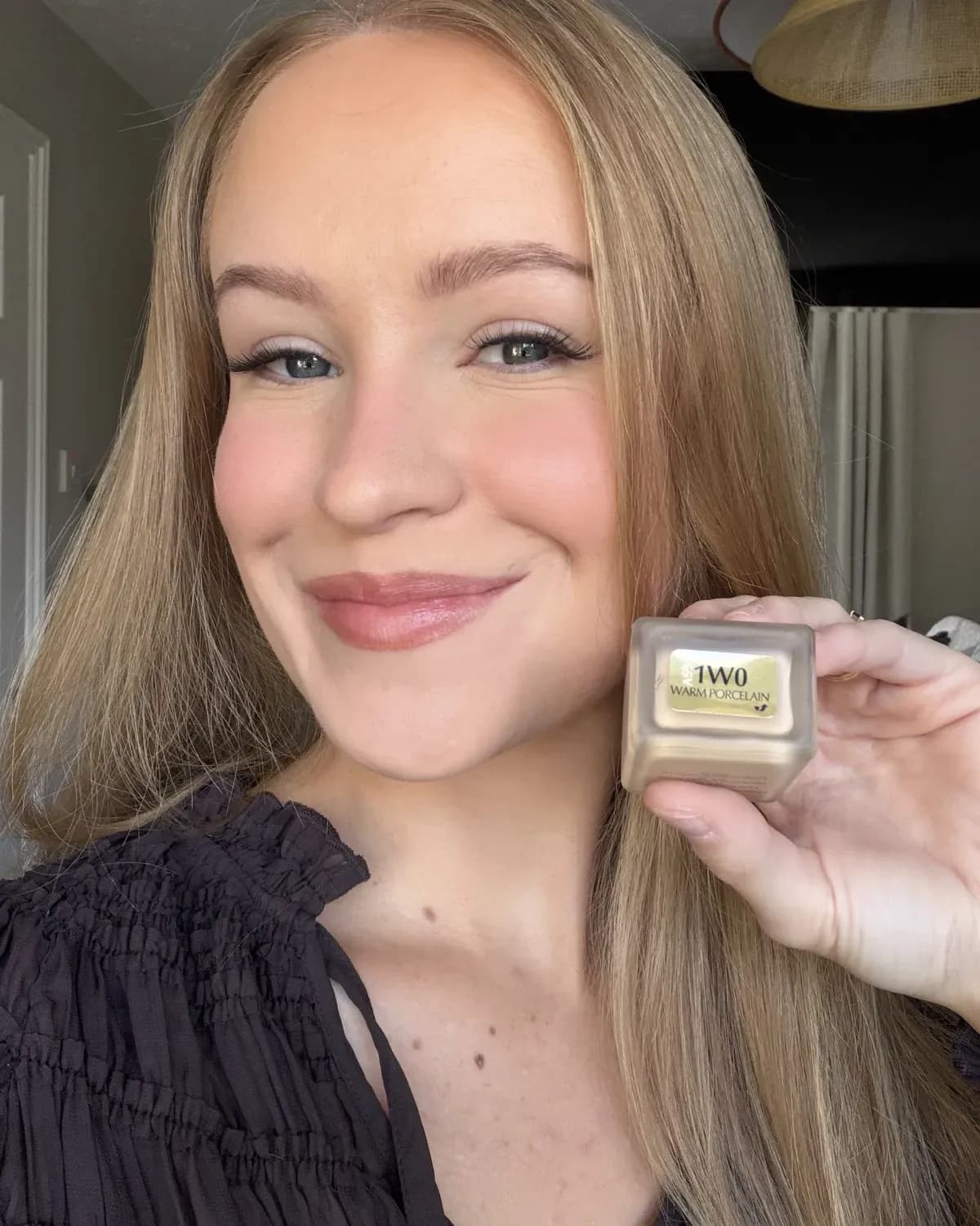 Me holding my bottle of Estee Lauder Double Wear in shade 1W0 Warm Porcelain