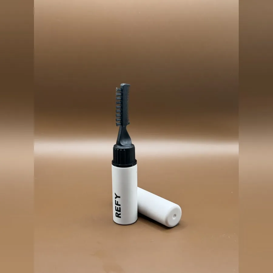 REFY Brow Sculpt in a white tube with its black comb applicator lifted out